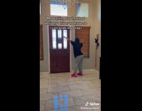 Girl in front of door window dancing food delivery