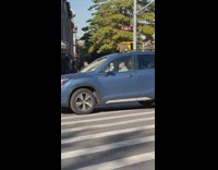 Kid in Costume Crosses Street with Man