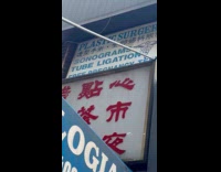 Woman films surgery sign next to Dunkin'