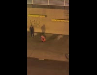 Guy poses in front of ACAB graffiti 