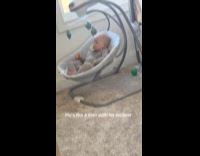 Baby climbs and sits on his own on rocker chair