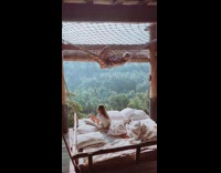 Two girls net hangs over swinging bed 