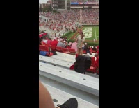 Girl NCAA Football fan dance audience chairs