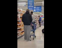 Guy puts trash can on person head in market 