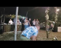Guy tries to jump through picture backdrop flower hoop at wedding, breaks it and falls down