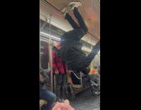 Man Hangs Upside Down inside Train and Dances