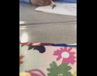 Kid wearing blue shirt doodles 