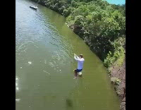 Guy backflips off cliff into ocean water