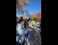Woman jumps happily runner drinks the beer