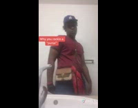 Red shirt guy brown purse bag bathroom