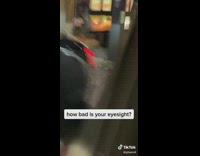 Woman standing outside of her car in drive thru in front of menu