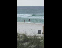 Guy jumps clicks heels beach shore jacket