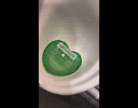 Urinal in the restroom with a tiny goal and ball inside