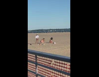 Curly girl bikini kneel sit sand  fence
