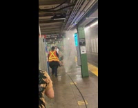Subway worker puts foot over water leak