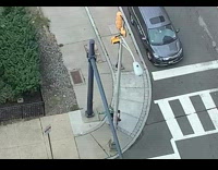 Guy walking down sidewalk plays bagpipes 