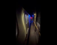 Man walk beside stuck train in tunnel