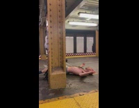 Guy rolls on station floor attached to woman walking 