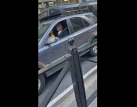 Guy plays maracas while singing in car 