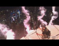 Guy watches fireworks from skyscraper tall building 