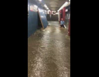 blue shirt man in flooded subway 