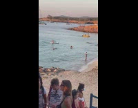 Guy jump from underwater shake body beach