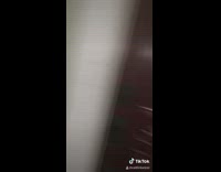 Small frog jumps at girl red door