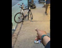 Guy flips water bottle into cupholder of bike 