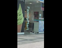 Cat lay outside family mart entrance door