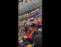 Black shirt girl game crowded arena seating 