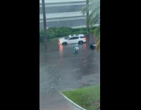 Man walks through knee deep flood