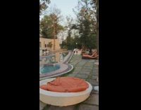 Black dress girl trips while walking resort 