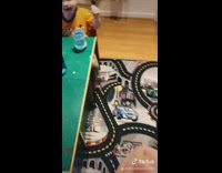 Mom rubs chocolate little boys forehead 