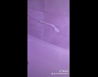 Shower head floating in bath tub