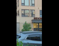 Man in building has two ring lights on him 