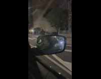 Man balance giant bed frame while riding scooter