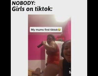 Red shirt mom dances holds black remote 