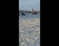 Woman in pink top polo tiktok dance at the beach