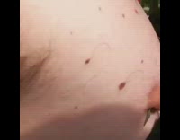 Shirtless guy green fish hook piercing beer 