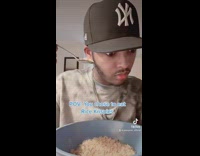 NY hat listening to cereal spoon 