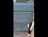 Woman sits with white object on foot