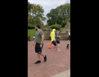 Guy wearing yellow duck costume at park 