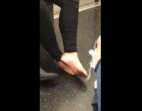 Woman ripped black jeans bare foot on subway train