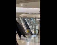 Man wears Batman costume films subway station