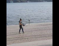 Guy dj turntable laptop around neck river