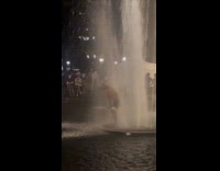 Man does push ups on fountain