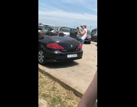 White shirt girl black convertible sports car 