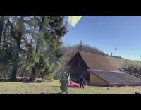 Woman launch paraglide gets stuck on trees