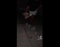 Guy dancing rips mcdonalds bag and friend slips on it