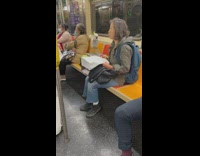 Woman shares food with pet bird on subway 